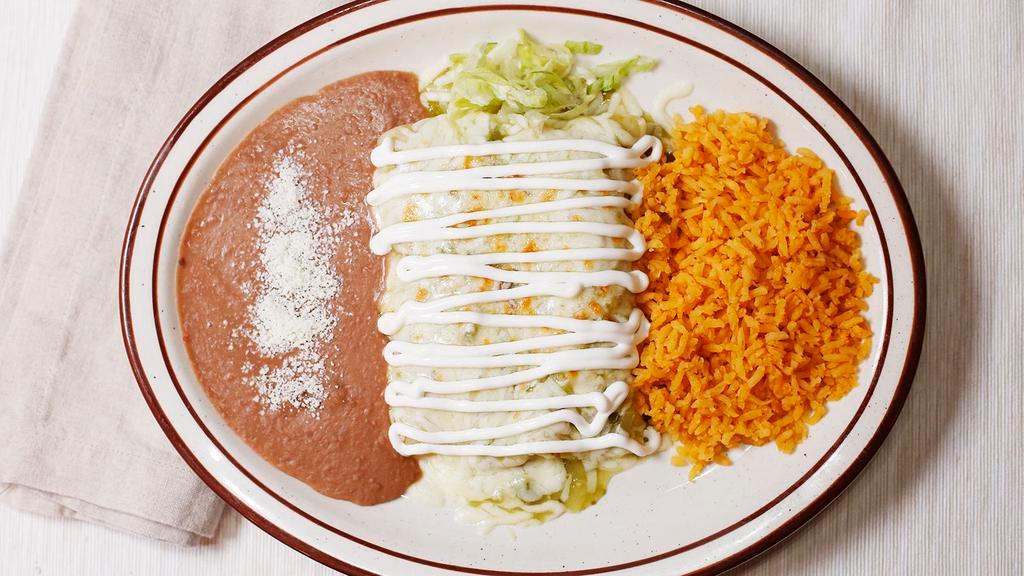 Enchiladas Verdes · Two chicken enchiladas topped with verde sauce, melted jack cheese, and sour cream, served with rice and beans.
CHIPS AND SALSA