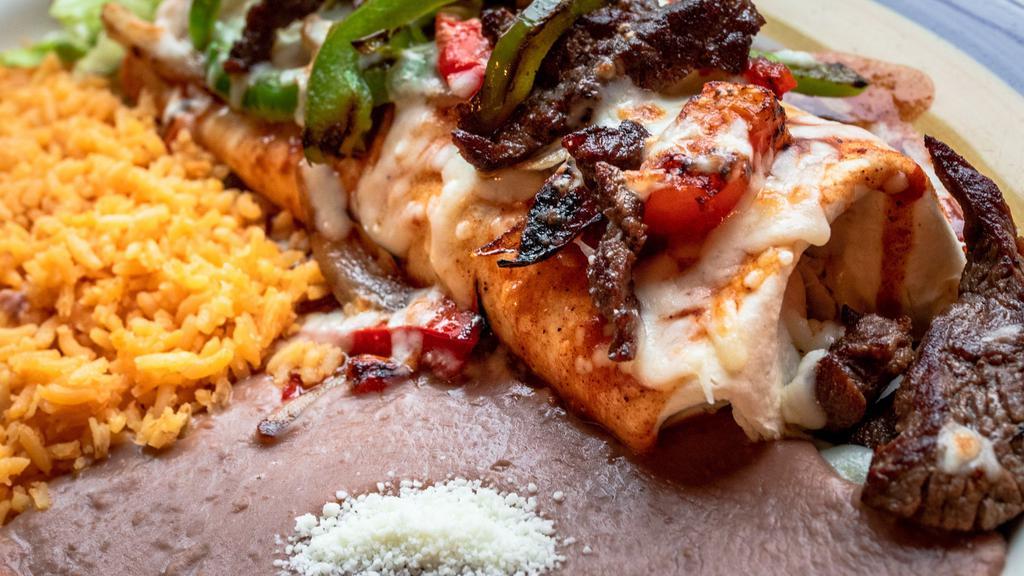 Fajita Burito · Your choice of steak or grilled chicken with bell pepppers, onions, and tomatoes. Wrapped in a large flour tortilla with beans. Topped with echilada sauce, melted cheese,