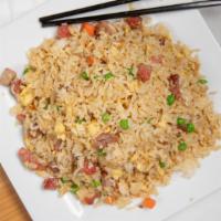 Pork Fried Rice / 叉烧炒饭 · Bbq pork pan-fried with steamed rice eggs peas and green onions.