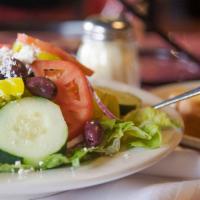 Greek Salad · Crisp mixed green lettuce tossed in a Greek vinaigrette then garnished with red onions, cucu...