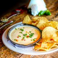 Queso Dip · Gluten-free. Tasty and creamy pepper jack cheese dip, flavored with poblano peppers. Served ...
