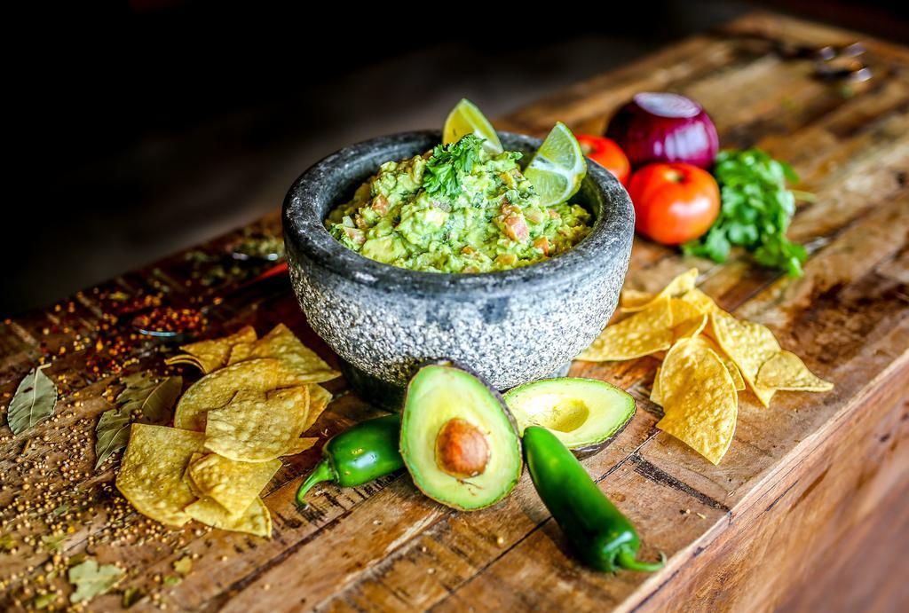 Guacamole · Gluten-free. We use the freshest of avocados, tomato, onions, cilantro, chopped jalapeño peppers, lime juice, and a special blend of sea salt, pepper, and garlic.