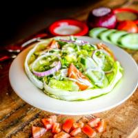 Mexican House Salad · Gluten-free. Seasonal mixed greens tossed with tomatoes, onions, queso fresco, and your choi...
