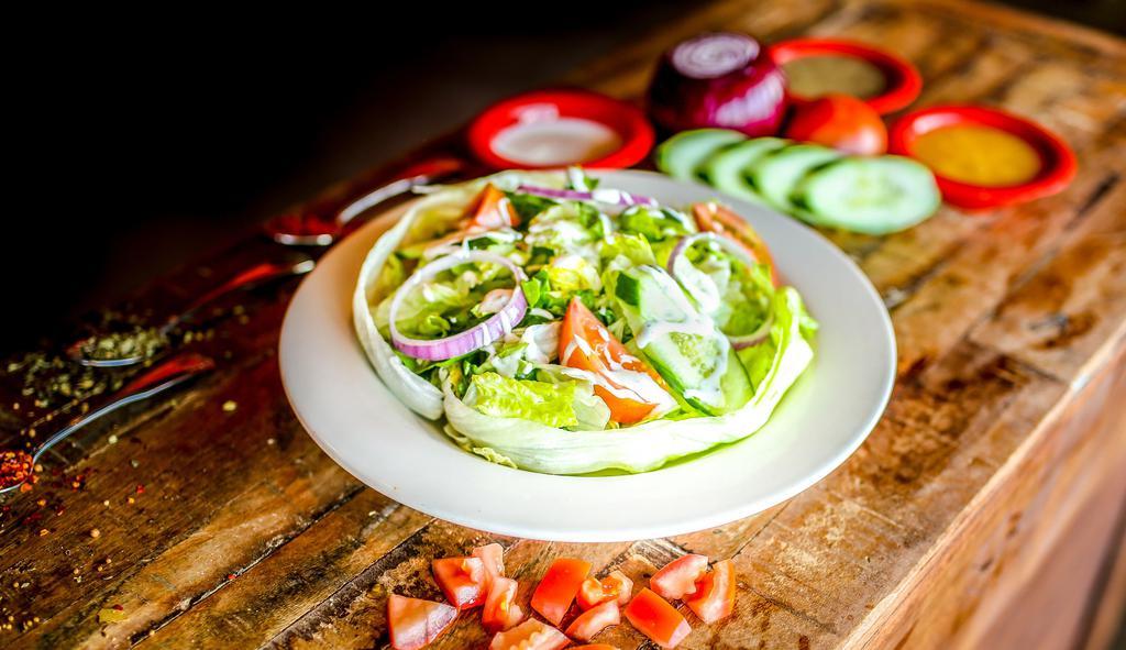Mexican House Salad · Gluten-free. Seasonal mixed greens tossed with tomatoes, onions, queso fresco, and your choice of dressing.