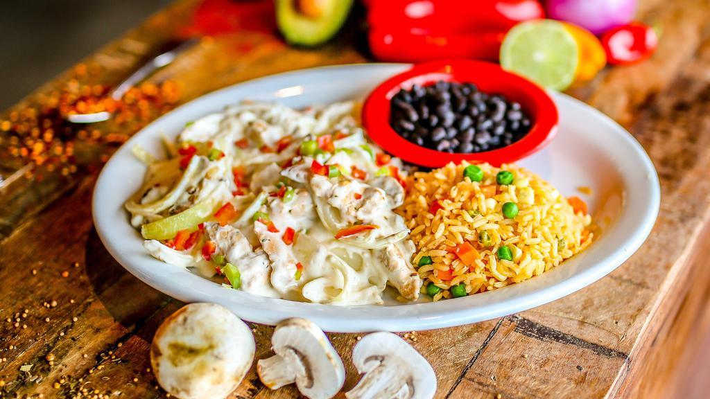 Arroz Con Pollo · Gluten-free. Plump sliced chicken breast sautéed with fresh mushrooms, onions with queso dip, Served over a bed of our Mexican rice.