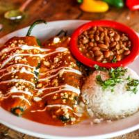 Dos Poblanos · Gluten-free. Mild poblano chiles stuffed with Jack cheese, shredded chicken, smothered with ...
