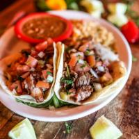 Tacos De Carnitas · Gluten-free. Three corn tortillas filled with tender flavorful slow-cooked pork, served with...
