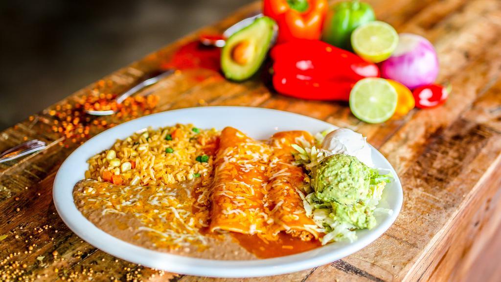 Enchiladas Mexicanas · Gluten-free. Three shredded chicken enchiladas covered with queso dip, lettuce, tomatoes, sour cream guacamole. Served with Mexican rice and refried beans.