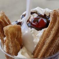 Churros · Delicious churros in a cup topped with whipped cream.