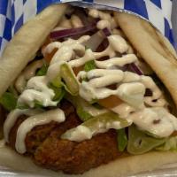 Falafel Sandwich · Comes with Lettuce, Tomato and Onion and topped with our Tahini Sauce wrapped in a Pita Bread
