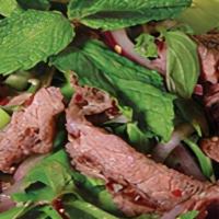 Yum Neau · Grilled sliced beef tossed with lettuce, onion, cucumber, tomato, cilantro, lime juice & chi...