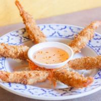 Coconut Shrimp · Fried breaded shrimp and coconut flake served with sweet and sour sauce.