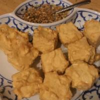 Fried Tofu · Crispy fried lightly battered tofu. Served with honey-vinegar sauce and ground peanuts.