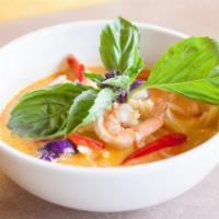 Kaeng Dang (Red Curry) · Red curry sauce and coconut milk simmered with bamboo shoots, eggplant, basil leaves, and be...