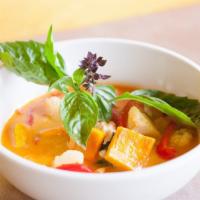 Pumpkin Curry · Red curry sauce and coconut milk simmered with pumpkin, pineapple, basil leaves, and bell pe...