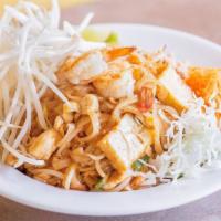 Pad Thai · Thai rice noodles stir-fried with egg, bean sprouts and green onions. Topped with ground pea...