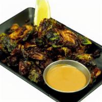 Brussel Sprouts · Crispy Brussel Sprouts tossed with our signature tare, lemon, & served with a side of Kotsu ...