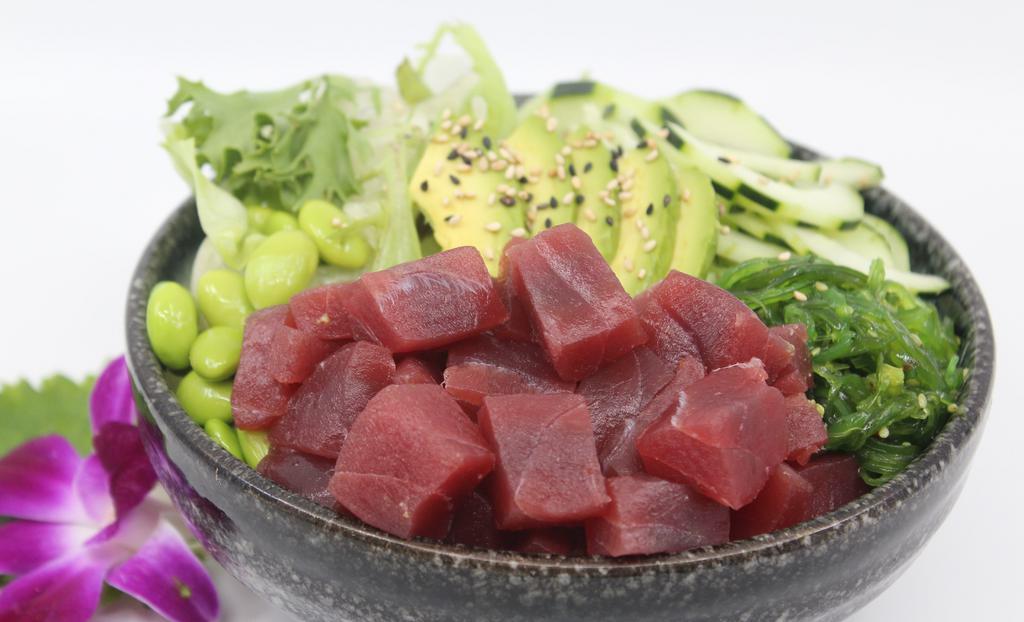 Ahi Tuna Poké Bowl · Choice of protein with rice base, pickled cucumber, avocado, edamame, green leaf lettuce and seaweed salad. Contains raw fish.