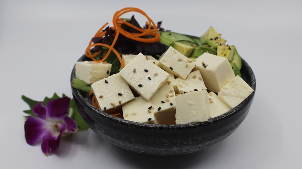 Tofu Poke Bowl · Choice of protein with rice base, pickled cucumber, avocado, edamame, green leaf lettuce and seaweed salad.