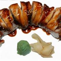 Dragon Roll · Inside: shrimp tempura, mixed crab and avocado Outside: sliced eel