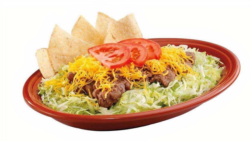 Taco Salad · Fat-free pinto beans, beef or chicken on a bed of shredded lettuce topped with Cheddar cheese and tomatoes.  Served with your choice of dressing or salsa on the side.