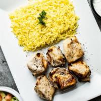 Chicken Tika · Chicken shish kabab on rice with side tzatziki and salad.