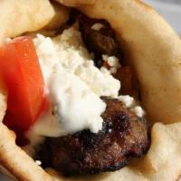 Grassfeed Lamb (8Oz) And Feta Burger Wrap · Ground Lamb charboiled with feta. Wrapped on pita bread with lettuce, tomato, grilled onions...