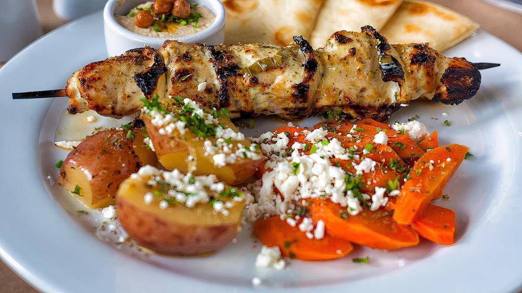 Chicken Souvlaki · Hand cut marinated chicken breast skewer char-broiled, served with a choice of greek lemon potatoes, rice pilaf, or greek fries, also braised fresh vegetables and pita bread.