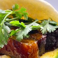 Sticky Pork Belly Bao · Braised pork belly, sweet and spicy pickles and cilantro.
