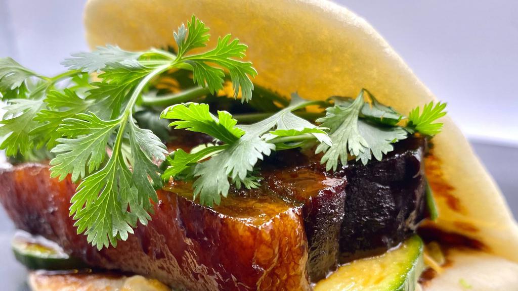 Sticky Pork Belly Bao · Braised pork belly, sweet and spicy pickles and cilantro.