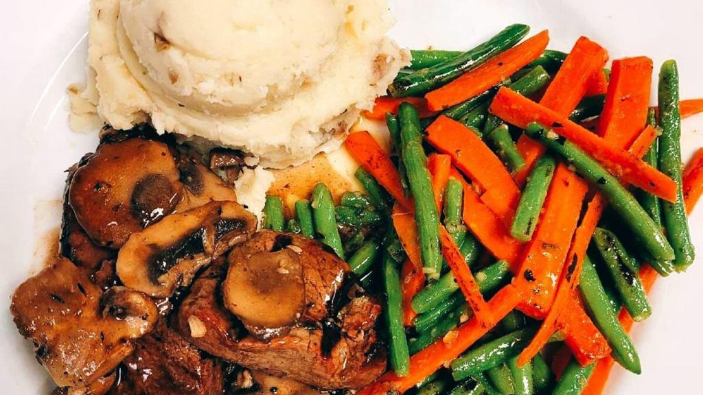 Steak Diane · Three filet medallions lightly seasoned and cooked to your liking and
 covered with a rich mushroom wine sauce.  Served with homemade garlic
 mashed potatoes, sautéed green beans & carrot medley.