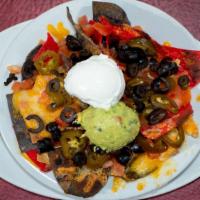 Mound O'Nachos · A mound of tortilla chips smothered with refried beans, cheddar and jack cheese, tomatoes, b...