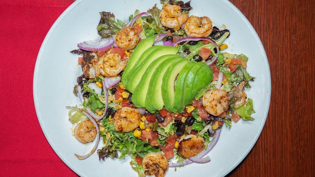 Shrimp & Avocado Salad · Fresh spring mixed lettuce, black bean and corn relish, diced tomatoes and sweet red onions tossed in a creamy spicy chipotle ranch dressing topped with blackened shrimp and fresh avocado.