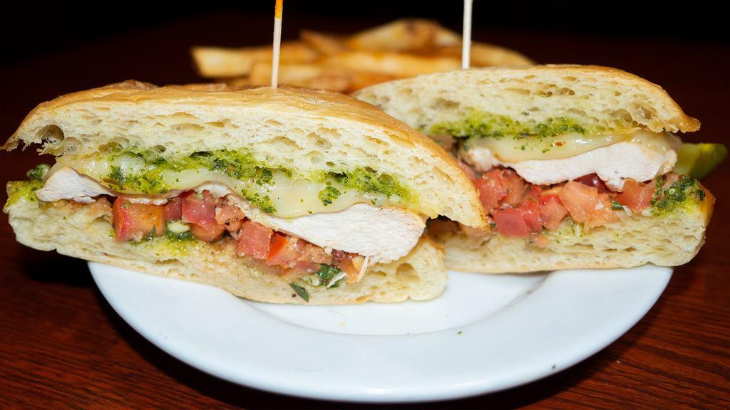 Pesto Chicken Sandwich · Grilled chicken breast, sweet basil pesto, diced marinated brushetta tomatoes, & mozzarella cheese. Served on a toasted ciabatta baguette.