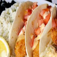 Baja Fish Tacos · Three flour tortillas filled with beer battered cod, fresh chipotle cabbage slaw, and diced ...