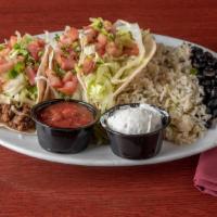 Street Tacos · Three flour tortillas filled with your choice of chicken, ground beef, or steak, with shredd...