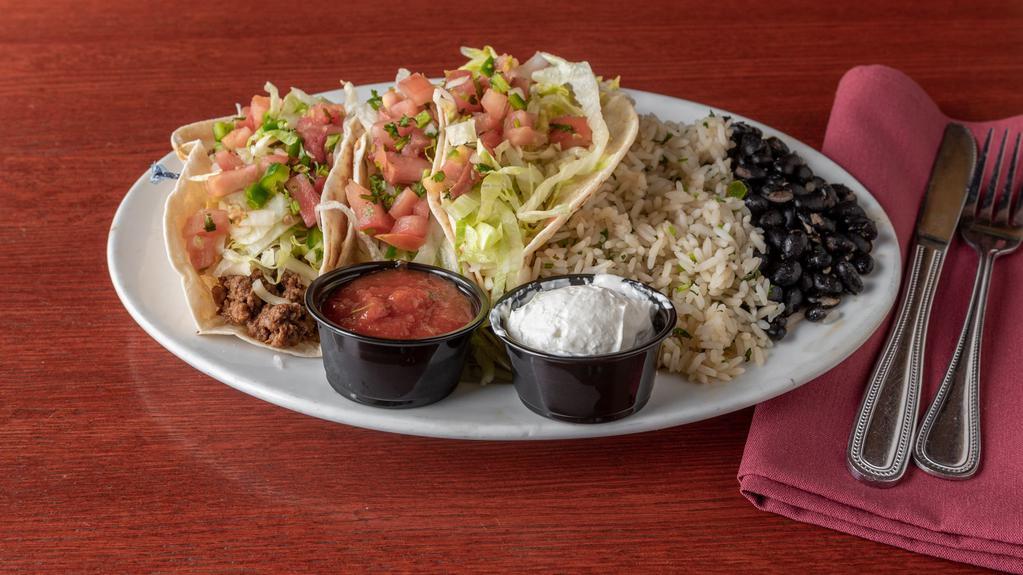 Street Tacos · Three flour tortillas filled with your choice of chicken, ground beef, or steak, with shredded lettuce, jack cheese, and fresh pico de gallo. Served with black beans, cilantro lime rice, sour cream, & our homemade salsa.