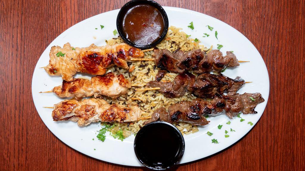 Grilled Skewers · Six mini skewers marinated in teriyaki sauce. Your choice of chicken, steak, shrimp or combination. Served over a bed of wild rice with sides of spicy chili ginger sauce & teriyaki glaze.