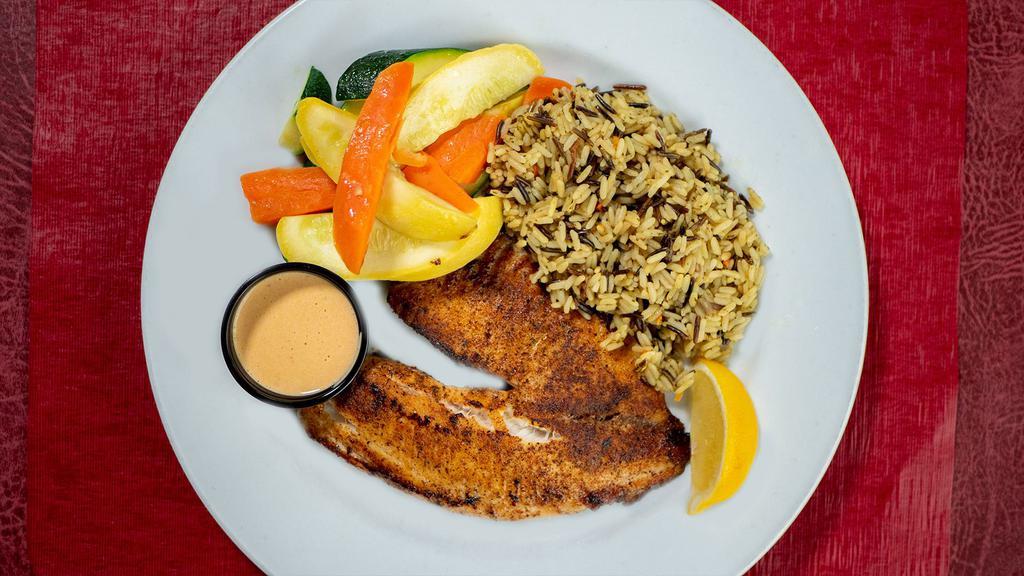Blackened Tilapia · Tilapia seasoned with Cajun spices, blackened in an iron skillet, and served with citrus chipotle sauce & a lemon wedge. Served with a side of vegetables and wild rice.
