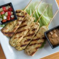 Yum Satay Gai - Chicken Satay Salad · Grilled chicken mixed with red onions and topped with cilantro, served on a bed of lettuce w...