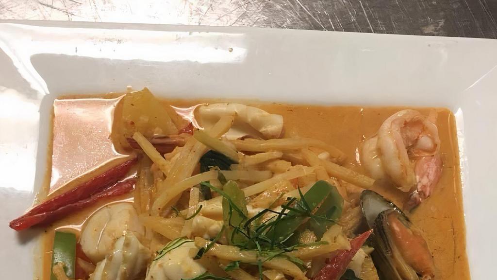 Seafood Curry · Spicy. With steamed rice. Shrimps, squids, fish, scallop and green mussels, bell pepper, pineapple, bamboo shoot, baby corn in red curry sauce.