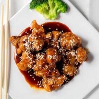Sesame Chicken芝麻鸡 · Crispy tender white meat chicken in sesame seed sauce and broccoli on the side.