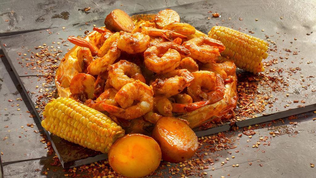 Shrimp · Plump Shrimp cooked with a perfect balance of garlic, lemon pepper, and cajun spices. Paired with corn and potatoes.