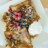 Meli Crepes · 3 crepes filled with honey infused Greek yogurt topped with blueberries, raspberries, choppe...
