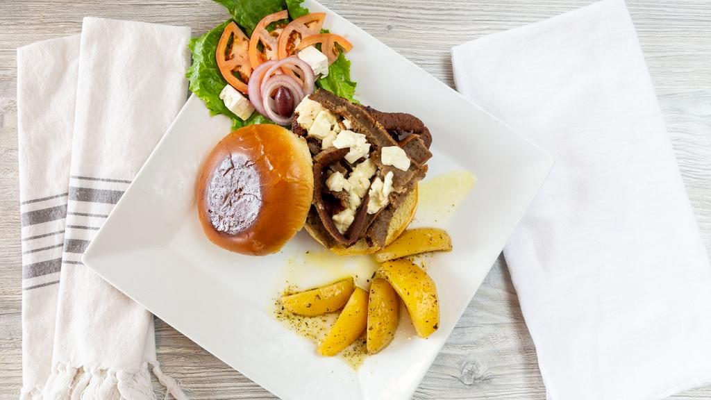 Big Greek Burger · Topped with strips of gyros and Feta cheese. All of our burgers are made with a half-pound of char-broiled certified Angus beef. Served with  french fries, red onions, tomato, pickle and lettuce on the side.