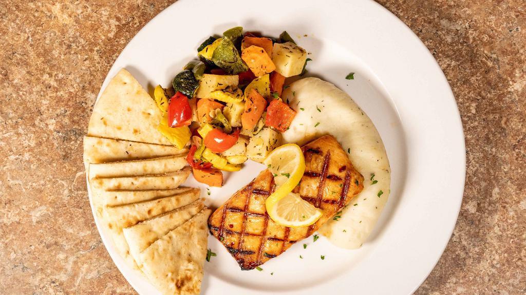 Pomegranate Salmon · charbroiled salmon filet,coated with house made pomegranate glaze .served with mashed potatoes roasted vegetables and warm fresh pita bread
