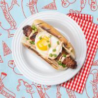 The Rise N' Shine Dog · Bacon wrapped dog topped with a fried egg, scallions, and sriracha mayo on a bun.