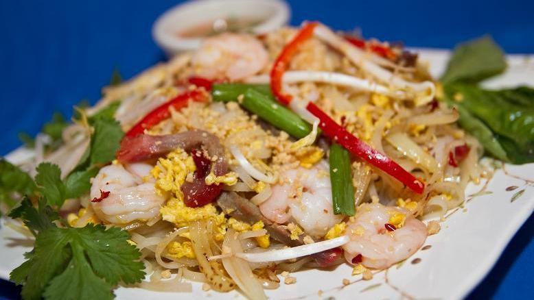 Red Ginger Pad Thai · Wok-tossed thai rice noodles with chicken, pork, beef, shrimp, egg, bean sprout, scallions and onion, fish sauce and topped with fresh cilantro, lime, basil and peanut.