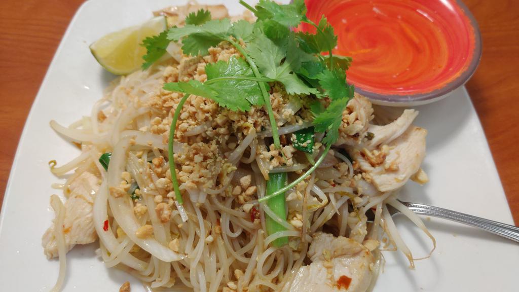 Chicken Pad Thai · Wok-tossed thai rice noodles with chicken, egg, bean sprout, scallions and onion, fish sauce and topped with fresh cilantro, lime, basil and peanut.