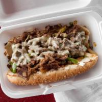 Philly Steak Sandwich · The sandwich consists of grilled onions, grilled bell peppers, lettuce, tomatoes, mayonnaise...
